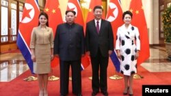 North Korean leader Kim Jong Un and wife Ri Sol Ju pose for a picture with Chinese President Xi Jinping and wife Peng Liyuan at the Great Hall of the People in Beijing, China in this picture released to Reuters on March 28, 2018. (Ju Peng/Xinhua via Reuters)