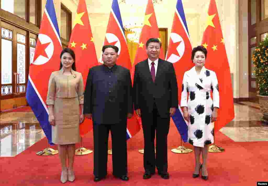 North Korean leader Kim Jong Un and his wife Ri Sol Ju pose for a picture with Chinese President Xi Jinping and wife Peng Liyuan at the Great Hall of the People in Beijing, China, March 28, 2018.