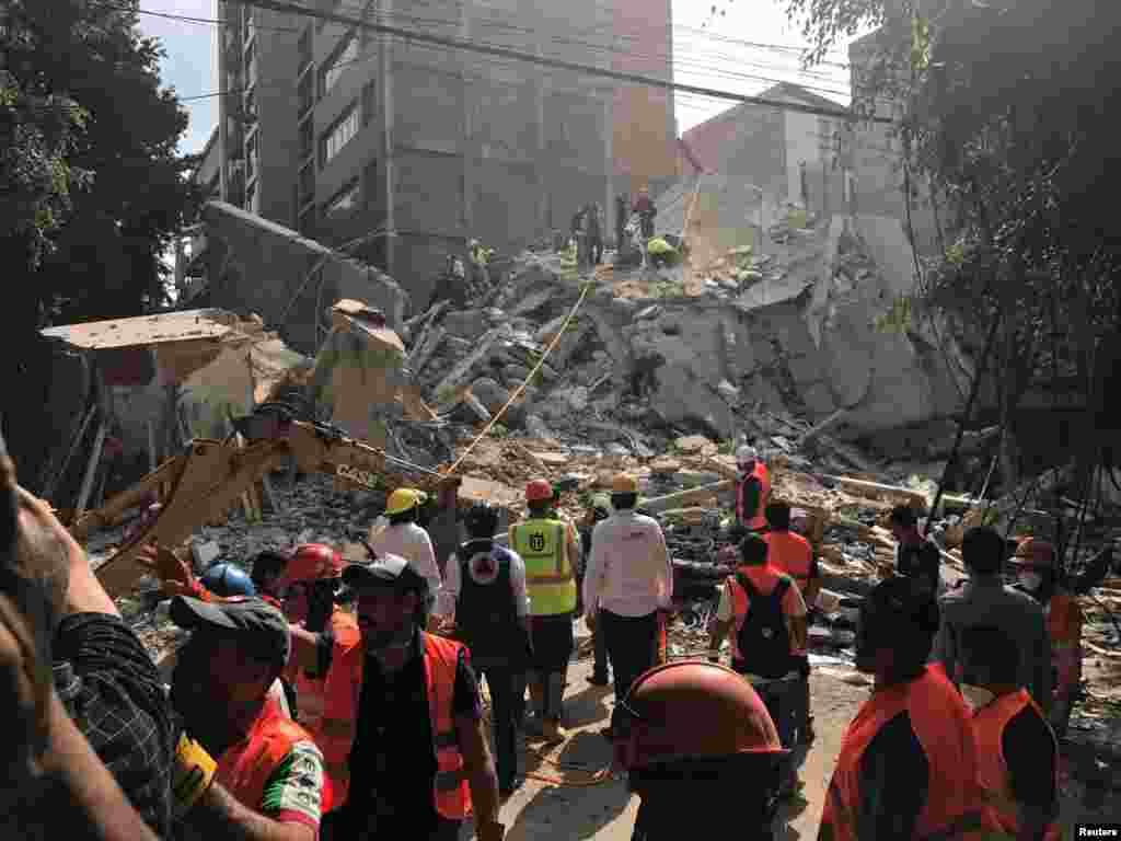 People clear rubble after an earthquake hit Mexico City, Mexico, Sept. 19, 2017. 
