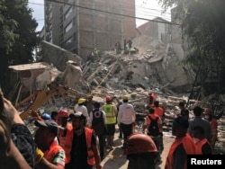 People clear rubble after an earthquake hit Mexico City, Mexico, Sept. 19, 2017.