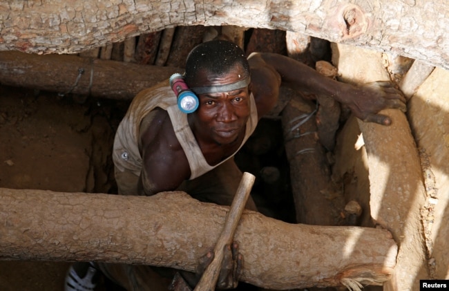 An artisanal gold miner emerges from a pit at an unlicensed mine near the city of Bouna, Ivory Coast, Feb. 11, 2018.