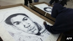 A supporter signs his name to a poster for Trayvon Martin 