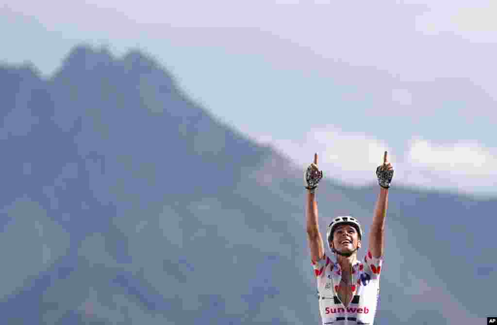 France's Warren Barguil, wearing the best climber's dotted jersey celebrates as he crosses the finish line to win the eighteenth stage of the Tour de France cycling race over 179.5 kilometers.