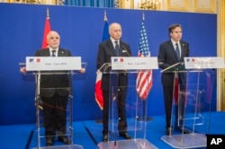 From left, Iraqi Prime Minister Haider al-Abadi, French Foreign Affairs Minister Laurent Fabius and U.S. Deputy Secretary of State Antony Blinken address the media after a meeting to discuss strategy in fighting the Islamic State group, in Paris, France,
