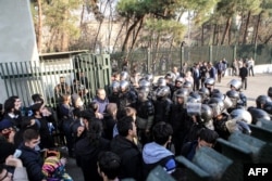 FILE - Iranian students scuffle with police at the University of Tehran during a demonstration driven by anger over economic problems, in the capital Tehran, Iran, Dec. 30, 2017.