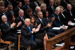 President Donald Trump, first lady Melania Trump, former President Barack Obama, Michelle Obama, former President Bill Clinton, former Secretary of State Hillary Clinton, former President Jimmy Carter, former applaud during a State Funeral for former President George H.W. Bush at the National Cathedral, Dec. 5, 2018, in Washington. In the second row are Vice President Mike Pence, and his wife Karen Pence, former Vice President Dan Quayle, and his wife Marilyn Quayle and former Vice President Dick Cheney and his wife Lynn Cheney, former Vice President Joe Biden and his wife Jill Biden.