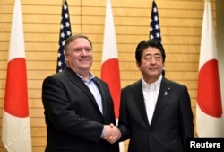 U.S. Secretary of State Mike Pompeo, left, meets with Japan's Prime Minister Shinzo Abe at Abe's official residence in Tokyo, July 8, 2018.