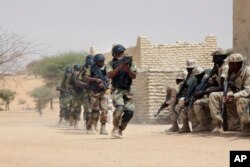 FILE- Nigerian special forces and Chadian troops participate with U.S. advisers in the Flintlock exercise in Mao, Chad, March 7, 2015.