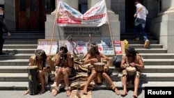 Members of the Khoi, an indigenous group, picket outside the high court during a hearing, as they oppose development of the new Africa headquarters and residential buildings of U.S. retail giant Amazon, in Cape Town, South Africa, Jan. 21, 2022.