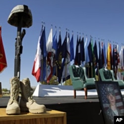 A soldier's memorial and photos are seen during a Remembrance Ceremony commemorating the one-year anniversary of the worst mass shooting on a U.S. military base, where 13 people were killed and dozens wounded, Friday, Nov. 5, 2010, in Fort Hood. (AP Photo