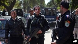 Egyptian police officers take positions during the arrest of Ahmed Qaddaf al-Dam, Cairo, March 19. 2013.