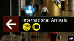 A sign for International Arrivals is shown at the Seattle-Tacoma International Airport, June 26, 2017, in Seattle, Washington. 