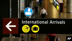 A sign for International Arrivals is shown at the Seattle-Tacoma International Airport, June 26, 2017, in Seattle, Washington. 