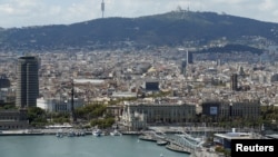 FILE - A view of Barcelona, with Maremagnum and Port Vell at habor, in Barcelona, Spain.
