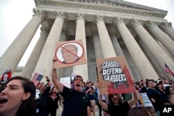 People protest on the steps of the Supreme Court after the confirmation vote of Supreme Court nominee Brett Kavanaugh, on Capitol Hill, Oct. 6, 2018 in Washington.