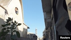 A resident walks on a damaged street in Hamidiyeh, Homs, Syria, July 1, 2012.