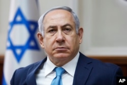FILE - Israeli Prime Minister Benjamin Netanyahu, shown at a weekly cabinet meeting in Jerusalem in February, says he's working on a new plan for African migrants in Israel.