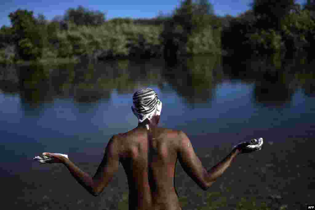 A Haitian migrant bathes at the Rio Grande river, in Ciudad Acuna, Coahuila state, Mexico.