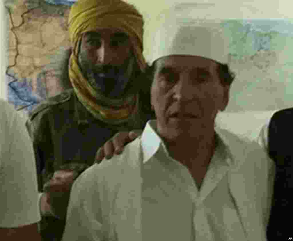 Libyan leader Moammar Gadhafi's former right-hand man Abdel Salam Jalloud (in white) at rebel headquarters in Zintan in this still image taken from video made available to Reuters on August 19, 2011.