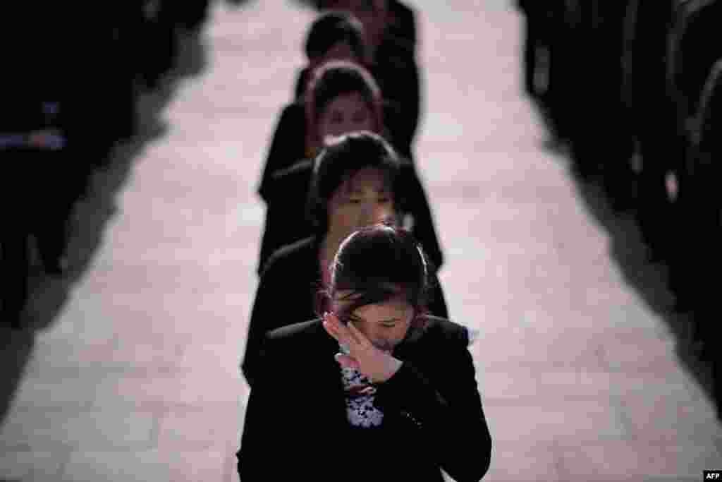 A woman wipes her eyes as she waits to pay her respects before the statues of late North Korean leaders Kim Il Sung and Kim Jong Il, as part of celebrations marking the anniversary of the birth of Kim Il Sung, known as the &#39;Day of the Sun,&#39; on Mansu hill in Pyongyang, April 15, 2019.