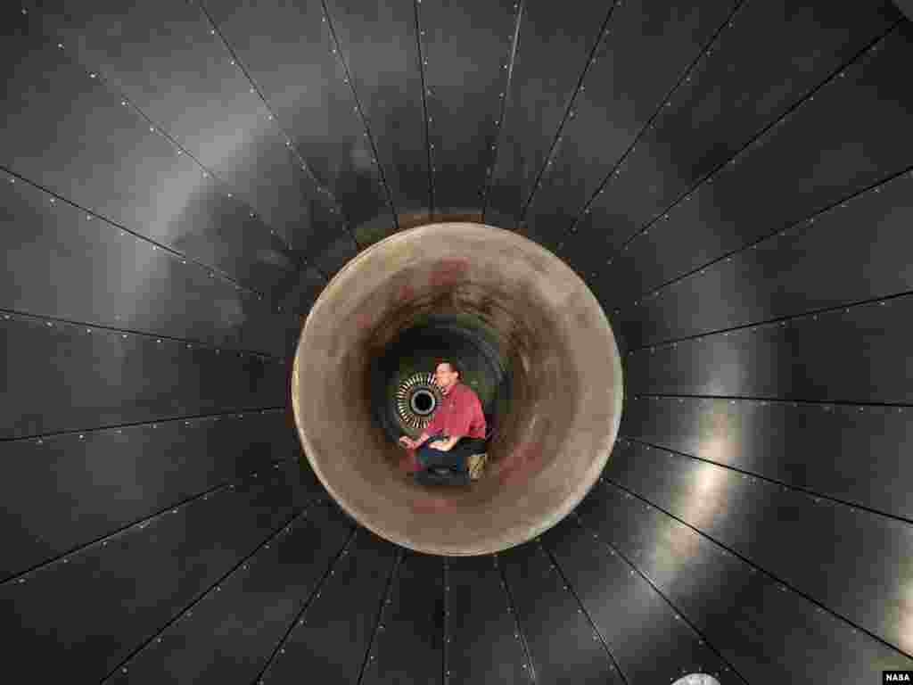 John Wargo, lead technician at NASA Glenn's Propulsion System Laboratory (PSL), performs an inspection on the inlet ducting, upstream of the Honeywell ALF 502 engine that was recently used for the NASA Engine Icing Validation test.