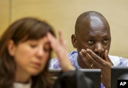 FILE - Congolese warlord Thomas Lubanga is seen at his appeals hearing at the International Criminal Court in The Hague Dec. 1, 2014.