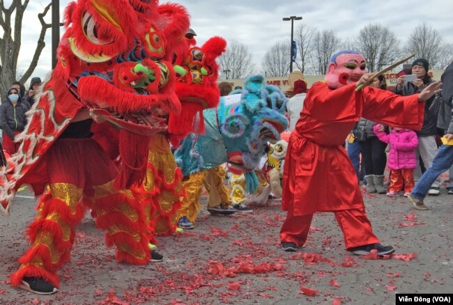 FILE - A dragon dance at Eden Center to celebrate the New Year of the Rooster