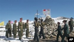 A delegation of the Indian Army, right, marches to meet the delegation of the Chinese army, left, at a Border Personnel Meeting (BPM) on the Chinese side of the Line of Actual Control at Bumla, Indo-China Border, Monday, Oct. 30, 2006.