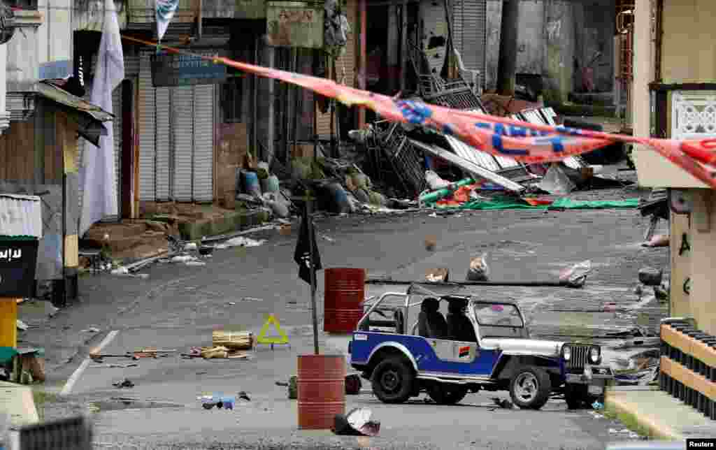 A view of the Maute group stronghold with an ISIS flag in Marawi City in southern Philippines. Philippine Marines advance their positions as more soldiers reinforce to fight the Maute group in Marawi City.