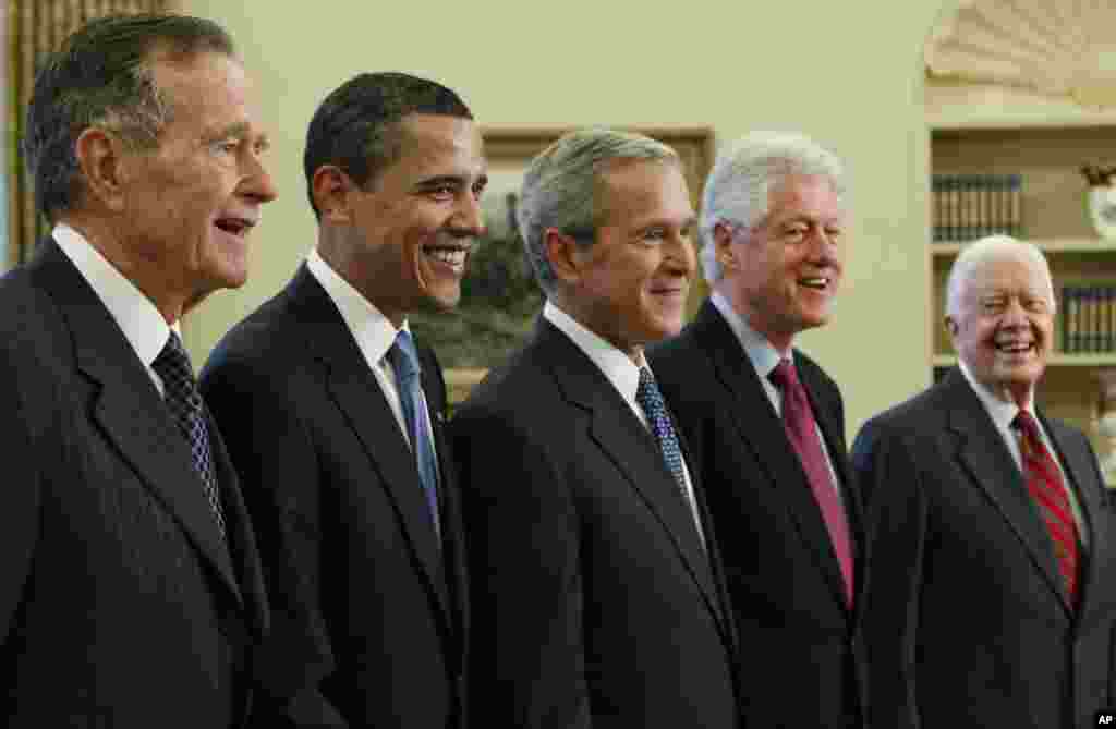 Then-President George W. Bush poses with President-elect Barack Obama, and former presidents George H.W. Bush, Bill Clinton and Jimmy Carter, January 7, 2009, in the Oval Office of the White House.