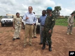 FILE - David Shearer, second left, the United Nations peacekeeping mission chief in South Sudan, visits the troubled region of Yei, South Sudan, July 13, 2017.