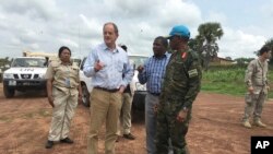 David Shearer, second left, the United Nations peacekeeping mission chief in South Sudan, visits the troubled region of Yei, South Sudan, July 13. 2017. Shearer says he's considering putting a permanent U.N. presence in the town, but only if the gove...