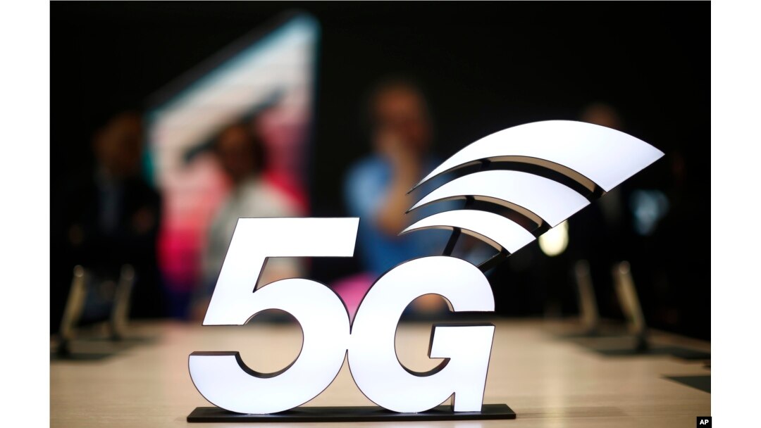 FILE - A banner of the 5G network is displayed during the Mobile World Congress wireless show, in Barcelona, Spain, Feb. 25, 2019.