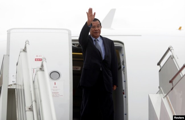 FILE - Cambodia's Prime Minister Hun Sen arrives at Phnom Penh International Airport before flying to China, in Phnom Penh, Cambodia, Nov. 29, 2017.