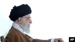 In this picture released by official website of the office of the Iranian supreme leader, May 10, 2017, Supreme Leader Ayatollah Ali Khamenei attends a graduation ceremony for Revolutionary Guard cadets in Tehran. Iran's supreme leader warned that anyone trying to foment unrest around the upcoming presidential election "will definitely be slapped in the face." 