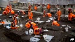 Archaeologists excavate the 16th and 17th century Bedlam burial ground uncovered by work on the new Crossrail train line next to Liverpool Street station in London, March 6, 2015.