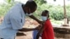 Villager gets vaccinated through mobile vaccination clinic in Pasani Village in Blantyre. (Lameck Masina/VOA)