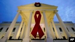 The White House in Washington is decorated to commemorate World AIDS Day, Dec. 1, 2021. 