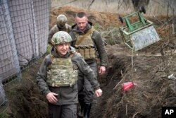 FILE - Ukrainian President Volodymyr Zelenskiy visits a front line in eastern Ukraine, April 9, 2021, where Russia-backed separatists have been battling Ukrainian troops in a conflict that since 2014 has killed more than 14,000 people.