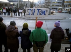People gather in front of the Alaska Capitol on Jan. 30, 2017, in Juneau, Alaska, to protest President Donald Trump's executive order affecting immigration and refugees.