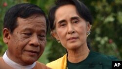 Leader of the National League for Democracy (NLD) party Aung San Suu Kyi, right arrives to participate in a gathering with newly elected lawmakers of NLD on Thursday, March 10, 2016 in Naypyitaw, Myanmar. 