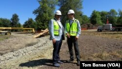 Aegis Living CEO Dwayne Clark (left) and development manager Brian Palmore at the future location of the Chinese-themed retirement home Aegis Gardens in Newcastle, Washington.