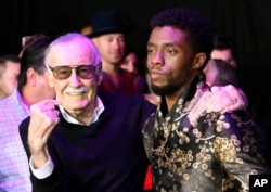 FILE - Comic book legend Stan Lee, left, creator of the "Black Panther" superhero, poses with Chadwick Boseman, star of the new "Black Panther" film, at the premiere at The Dolby Theatre in Los Angeles, Jan. 29, 2018.