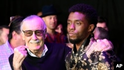 FILE - Comic book legend Stan Lee (L), creator of the "Black Panther" superhero, poses with Chadwick Boseman, star of the new "Black Panther" film, at the premiere at The Dolby Theatre in Los Angeles, Jan. 29, 2018.