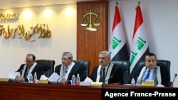 Iraqi judges attend a court session at the Supreme Judicial Council in Baghdad on Dec. 27, 2021, as the court is set to announce the verdict in the bid filed by the Hashed al-Shaabi ex-paramilitary alliance. 