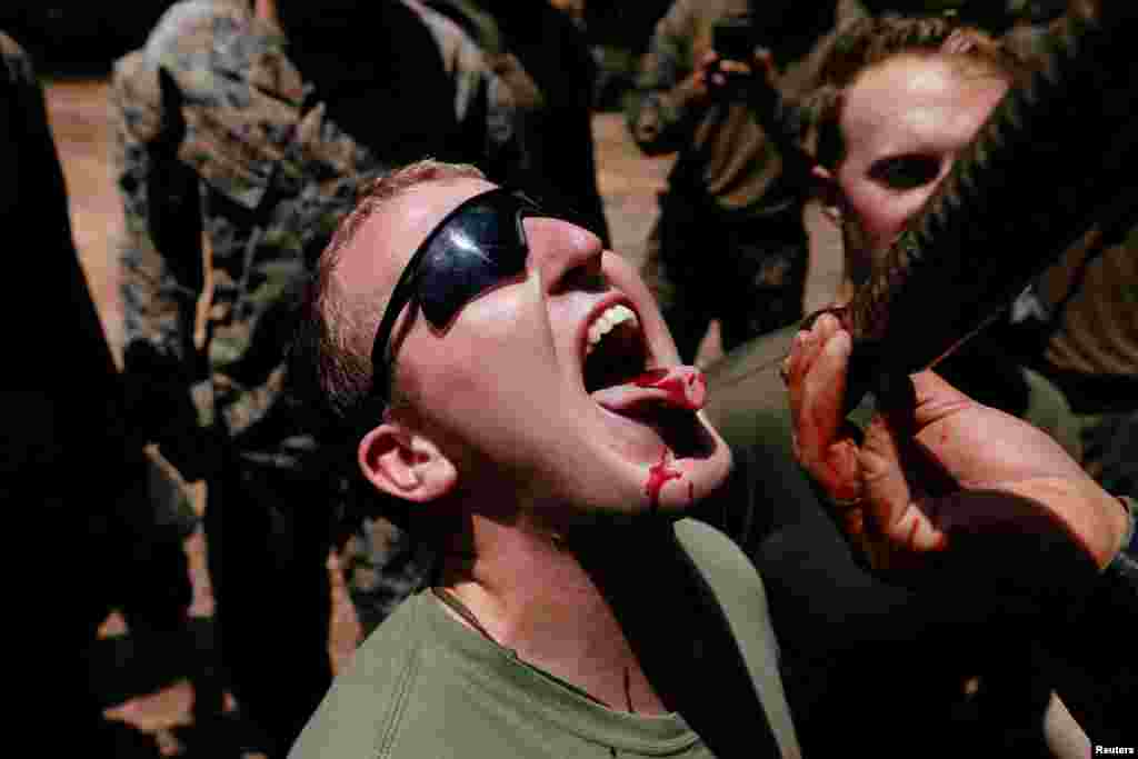 A soldier is fed snake blood during the Cobra Gold multilateral military exercise in Chonburi, Thailand.
