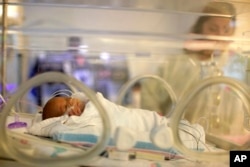 In this 2011 photo, Melinda Star Guido lies in an incubator at the Los Angeles County-USC Medical Center in Los Angeles.