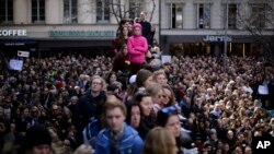 Thousands of people attends a "Lovefest" vigil against terrorism in central Stockholm, Sweden, Sunday, April 9, 2017. A hijacked truck was driven into a crowd of pedestrians and crashed into the department store on Friday in the Swedish capital. 