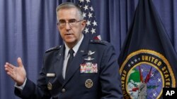 FILE - General John Hyten, the incoming commander of the United States Strategic Command, speaks to reporters following a change of command ceremony at Offutt Air Force Base in Bellevue, Nebraska, Nov. 3, 2016.