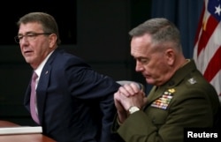 U.S. Defense Secretary Ash Carter, left, and Joint Chiefs Chairman Marine Gen. Joseph Dunford speak at the Pentagon in Washington, Feb. 29, 2016. Carter said the Syrian cease-fire, if "properly adhered to," could lead to a decline in violence.